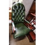 A green leather button backed office chair