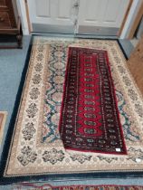Blue and cream rug and red runner rug