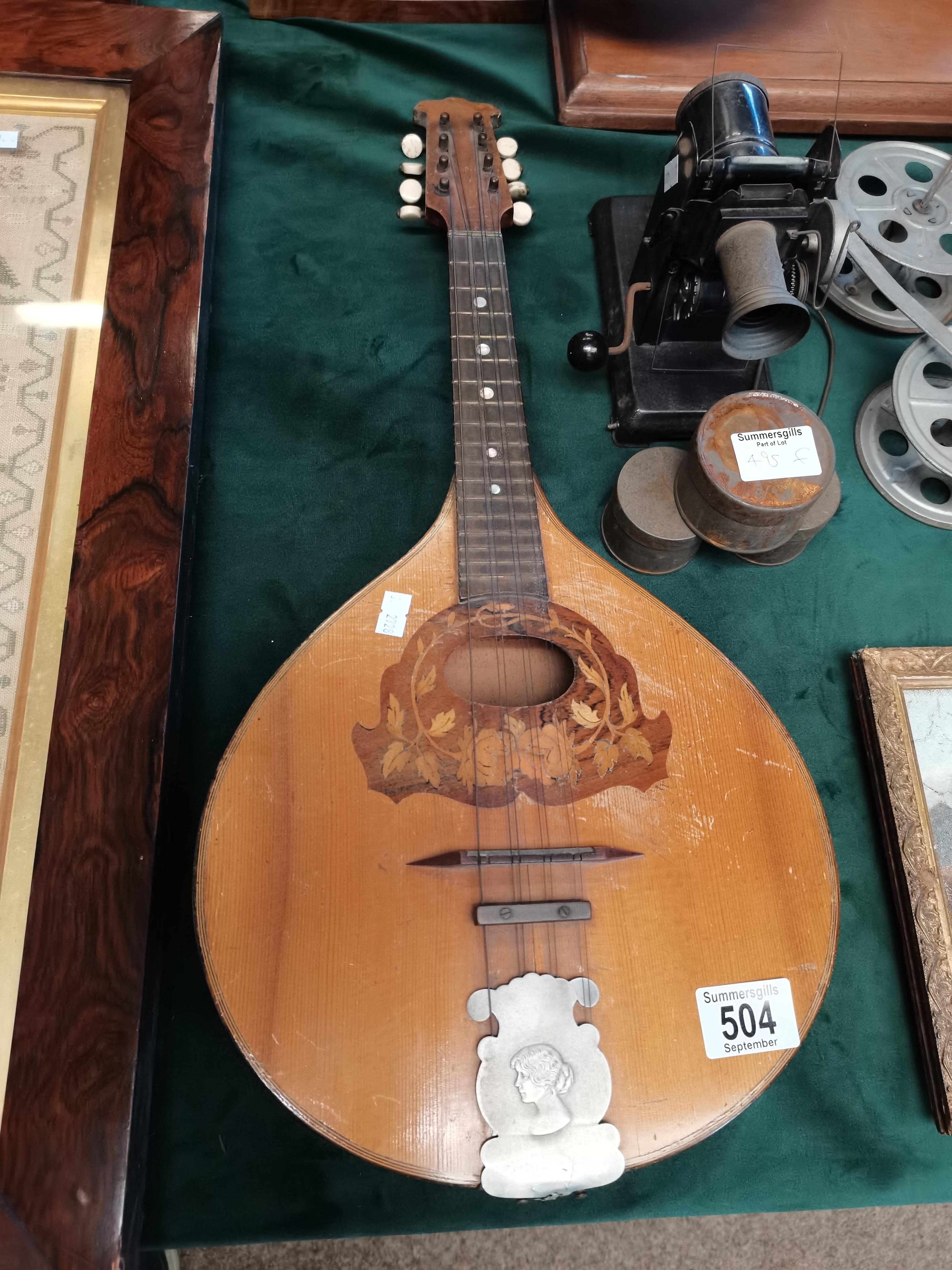 A vintage mandolin with marquetry and metal decora