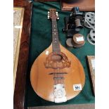 A vintage mandolin with marquetry and metal decora