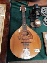 A vintage mandolin with marquetry and metal decora