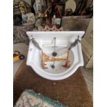 Antique sink with brackets, cast iron ceiling rose and Victorian tiles