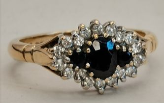 A 9ct gold wedding style ring with 3 x blue stones