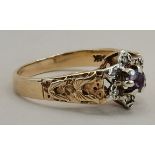 A 9ct gold ring with diamond chipping with a centr
