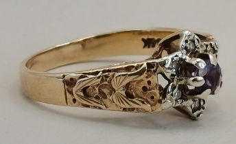 A 9ct gold ring with diamond chipping with a centr