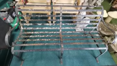 Antique iron garden bench in need of restoration