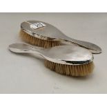 A PAIR OF GEORGE V SILVER-BACKED HAIR BRUSHES