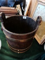 A vintage oak and brass water bucket