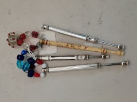 Four lace bobbins, including silver examples