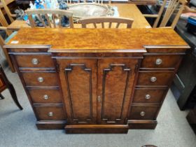 A walnut breakfront sideboard with 8 drawers and 2