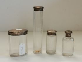 FOUR LATE VICTORIAN SILVER-TOPPED DRESSING TABLE JARS