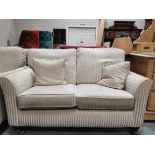 Neutral 2 seater sofa with contrasting stripes and matching armchair on castors