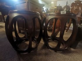 A pair of Chinese mahogany style low tables / stools