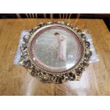 An Italian style antique gilt circular framed picture with highly decorative carving