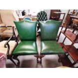 A pair of green leather hall /office chairs with Q