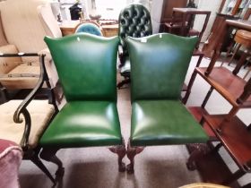 A pair of green leather hall /office chairs with Q