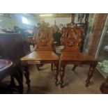 A pair of oak Antique hall chairs