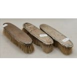 THREE SILVER-BACKED DRESSING TABLE BRUSHES