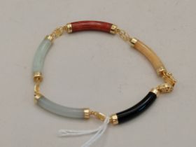 A 14 carat gold mounted multi-coloured jade bracelet