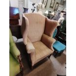 An Edwardian wing back chair with mahogany fluted