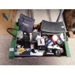 A Box of Cameras and Camera Equipment