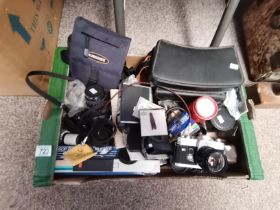 A Box of Cameras and Camera Equipment