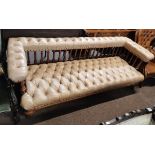 A Victorian settee with turned spinal supports and