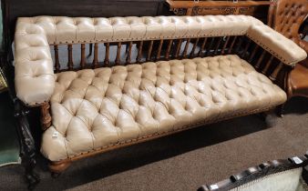 A Victorian settee with turned spinal supports and