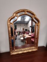 A gilt modern wall mirror