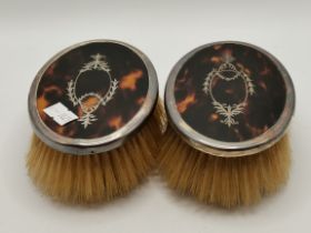 A pair of Edwardian silver-mounted tortoiseshell dressing table brushes