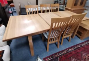 A modern extending oak dining table and 5 chairs 2