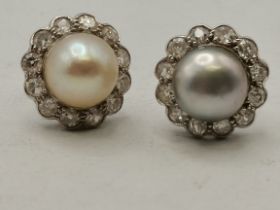 A pair of split pearl stud earrings with white stones