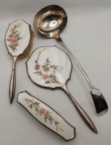 An enamel and silver-plated three-piece dressing table set, and a ladle