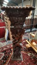 A 1.2m carved Portuguese column plinth with cherub decoration