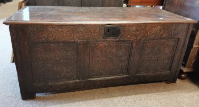 An early oak blanket box with carved front 1.3m lo