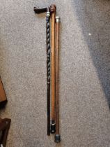 2 ornate carved wooden walking sticks plus one with Silver top