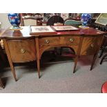 A Regency inlaid mahogany serpentine sideboard