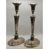A pair of late Victorian silver candle sticks