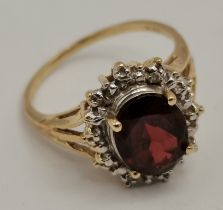 Garnet & Diamond oval cluster ring set in 14ct gold