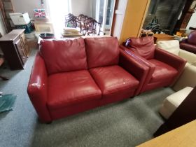 A red/ burgundy leather settee and chair