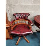 Captains Chair finished in Oxblood red leather on castors.