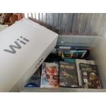 A Box Containing A "Wi" Computer and various accessories and Games