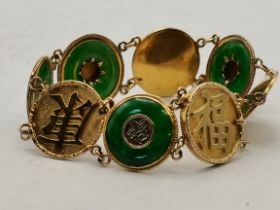 An 18ct gold and jade bangle with Chinese character marks