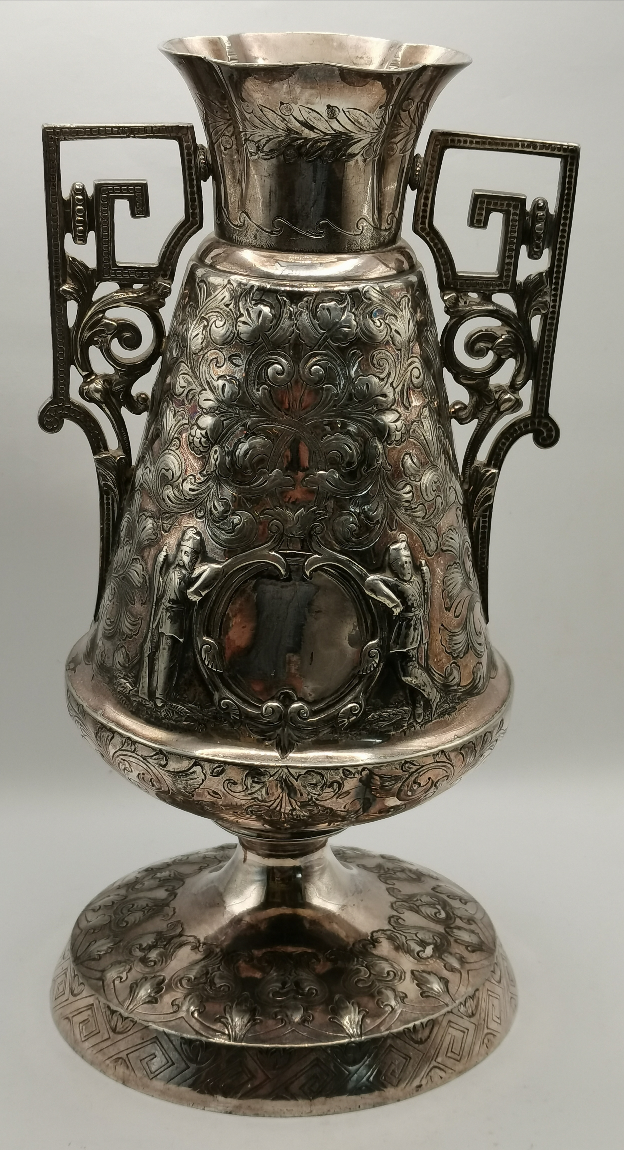 A highly decorated silvered vase 30cm high with so