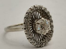 An American Art Deco style diamond ring, c.1920swith central diamond and encompassed by several smal