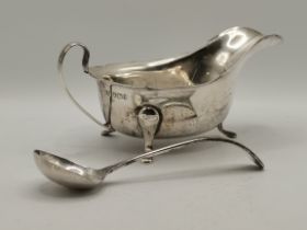 A 20th Century silver sauceboat and ladle