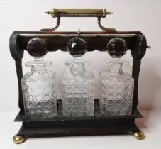 A silver-plated three-bottle tantalus, late 19th/early 20th Century