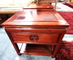 A pair of Chinese mahogany bedside cabinets
