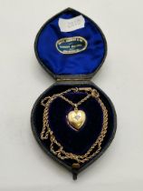 A 15ct gold white stone-set heart locket pendant on a 9ct gold chain
