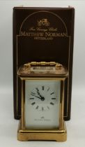 A Matthew Norman Carriage Clock in Brass with box and key